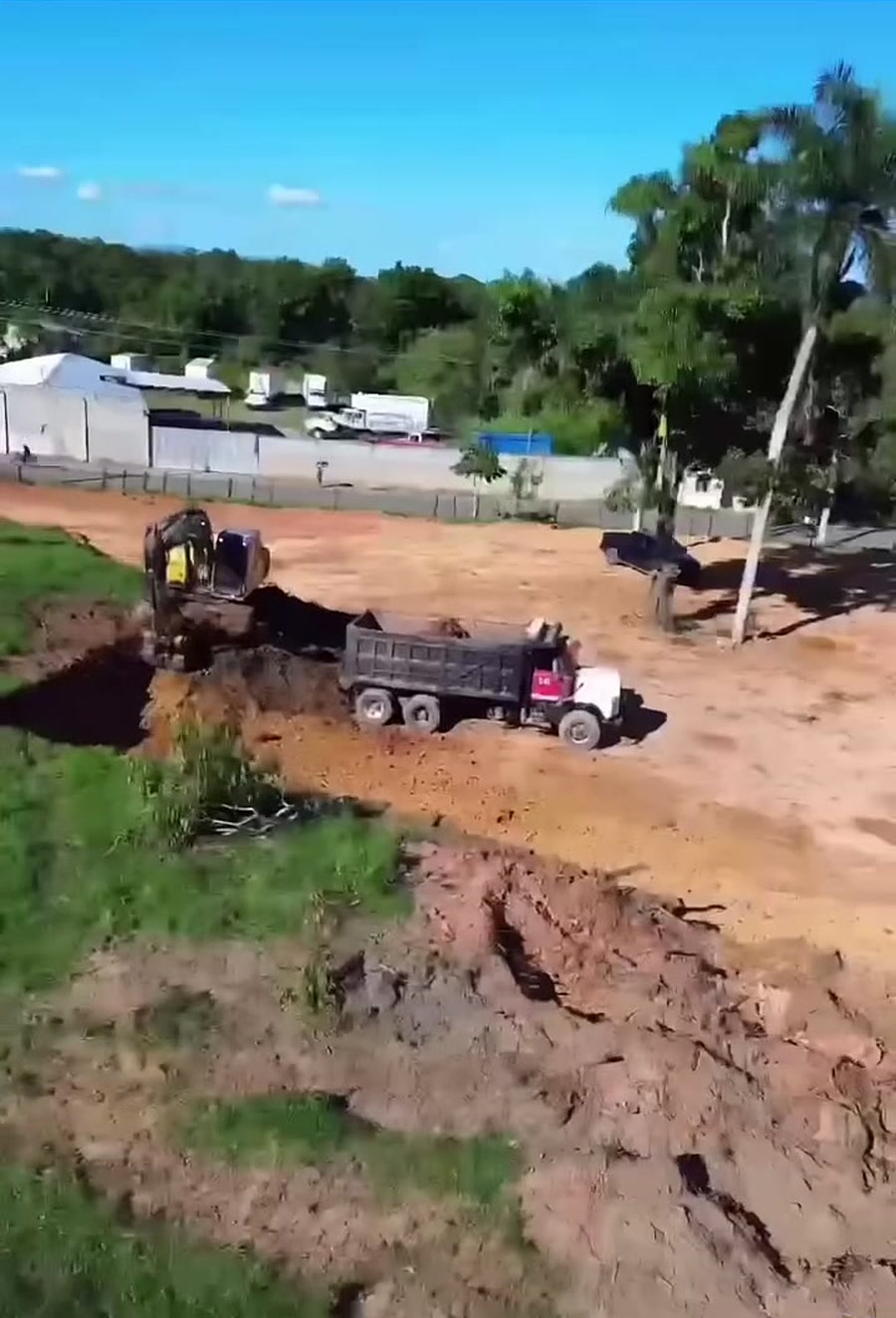 Excavadora cargando un camión en un terreno en corte y nivelación